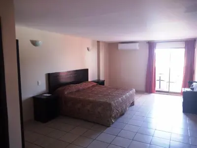 Cama o camas de una habitación en Los Jitos Hotel & Suites