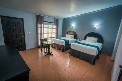 Cama o camas de una habitación en InHouse Select Hacienda Tres Rios Hotel Culiacán