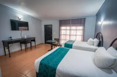Cama o camas de una habitación en InHouse Select Hacienda Tres Rios Hotel Culiacán