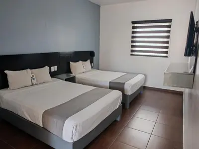 Cama o camas de una habitación en Aló Select Mazatlan