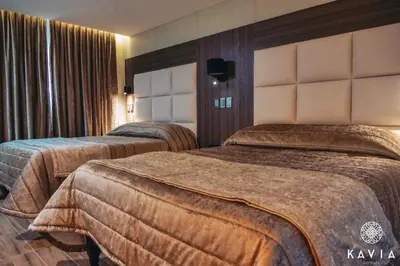 Cama o camas de una habitación en KAVIA MEOQUI HOTEL & SUITES