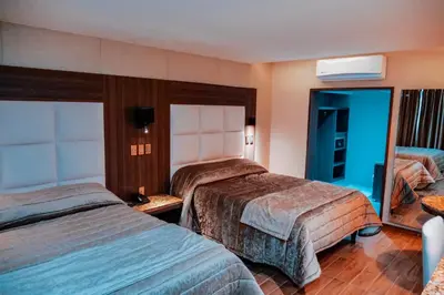 Cama o camas de una habitación en KAVIA MEOQUI HOTEL & SUITES