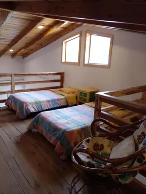 Cama o camas de una habitación en Hermosa y cálida casa tipo cabaña
