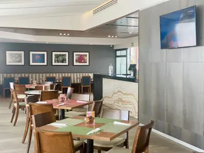Una televisión o centro de entretenimiento en Hotel Buen Valle