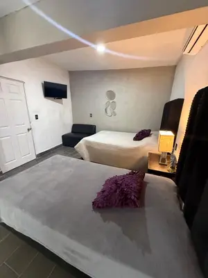 Cama o camas de una habitación en La Casita Inn Bustamante