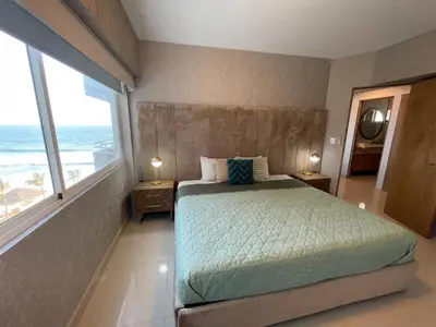 Cama o camas de una habitación en a pie de playa con hermosa vista by G P S rentas
