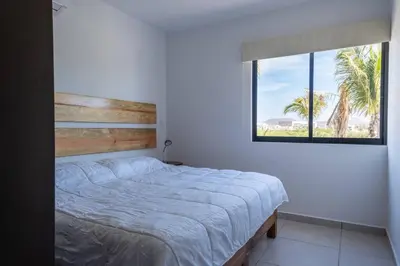 Cama o camas de una habitación en Familiar Departamento Cerca de la Playa