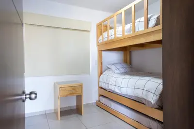 Cama o camas de una habitación en Familiar Departamento Cerca de la Playa