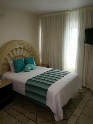 Cama o camas de una habitación en Hotel Playa Marina